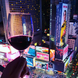View of Times Square with a glass of wine