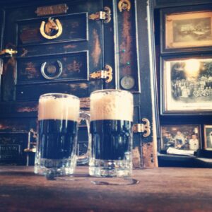 Two beers at the bar at McSorley's